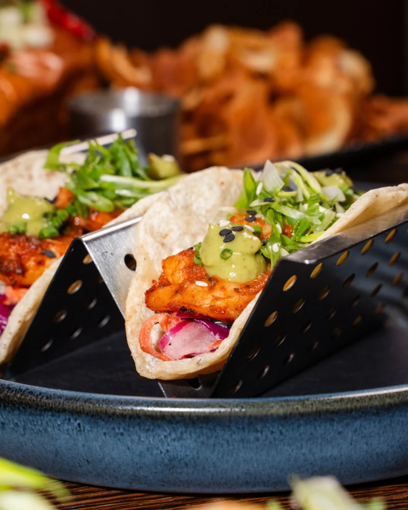Blackened shrimp taco with avocado and pickled onion