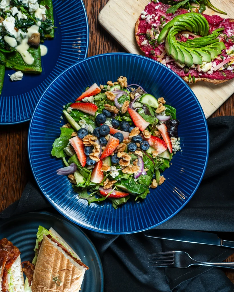 Spring salad with berries beside toasted sourdough